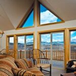 Great room with large vinyl windows framing a mountain view