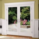 White fiberglass hinged patio doors opening onto a garden patio