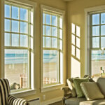 Sunroom with large fiberglass windows overlooking the water