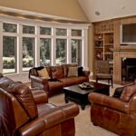 Living room with a wall of fiberglass windows and a fireplace