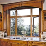 Wood-clad window above a kitchen sink overlooking the hills