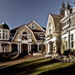 Shingle-style estate home with multiple gables and wood-clad windows