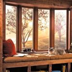 Wood-clad window seat reading nook at sunset