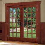 Wood-clad fiberglass French doors with divided-light glass opening to a garden